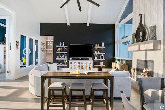 living room with vaulted ceiling with beams, a fireplace, and hardwood / wood-style flooring