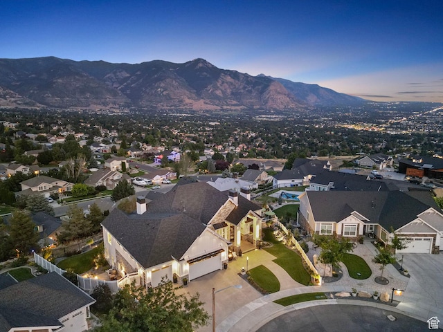 aerial view at dusk featuring a mountain view