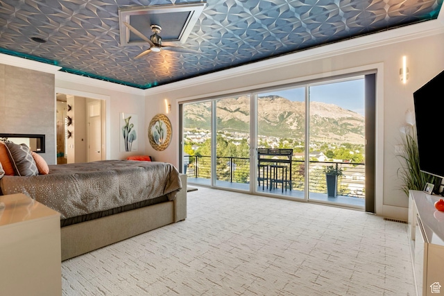 carpeted bedroom with ornamental molding and access to outside