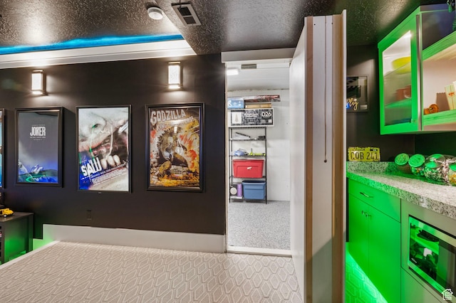 interior space featuring a textured ceiling, carpet flooring, and wine cooler