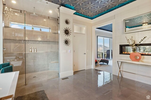 bathroom featuring a mountain view, an enclosed shower, and crown molding