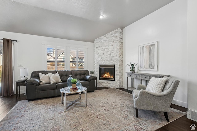 6228 W Apollo Way, Highland, UT 84003 - living room featuring a textured ceiling, dark hardwood / wood-style floors, a stone fireplace, and vaulted ceiling