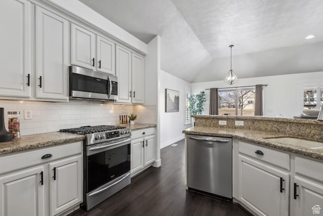 6228 W Apollo Way, Highland, UT 84003 - kitchen featuring lofted ceiling, white cabinets, appliances with stainless steel finishes, and hanging light fixtures