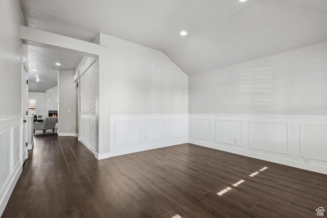 6228 W Apollo Way, Highland, UT 84003 - bonus room featuring dark wood-type flooring, lofted ceiling, and a stone fireplace