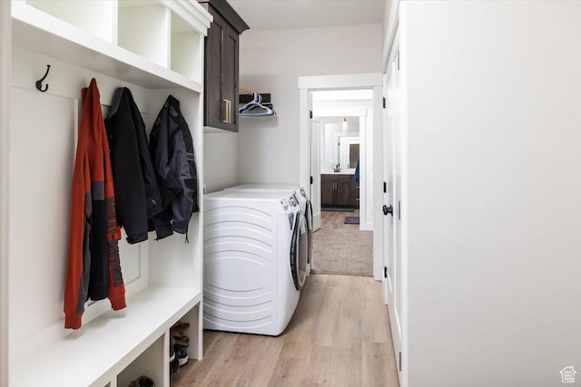 mudroom featuring washer and dryer and light hardwood / wood-style floors