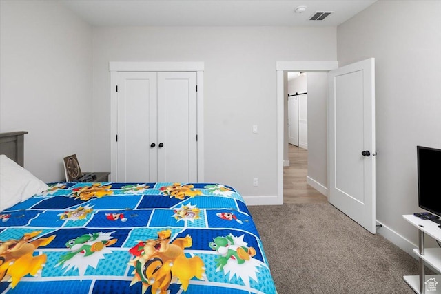 carpeted bedroom featuring a closet
