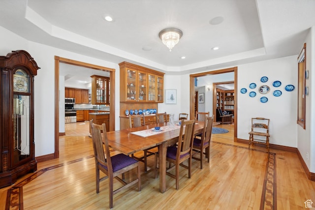 1 Spyglass Ct, Park City, UT 84060 - dining area with light wood-type flooring and a tray ceiling