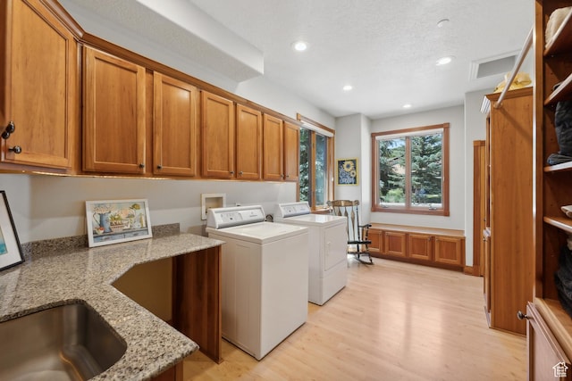 1 Spyglass Ct, Park City, UT 84060 - laundry area featuring cabinets, light hardwood / wood-style floors, washing machine and clothes dryer, and sink