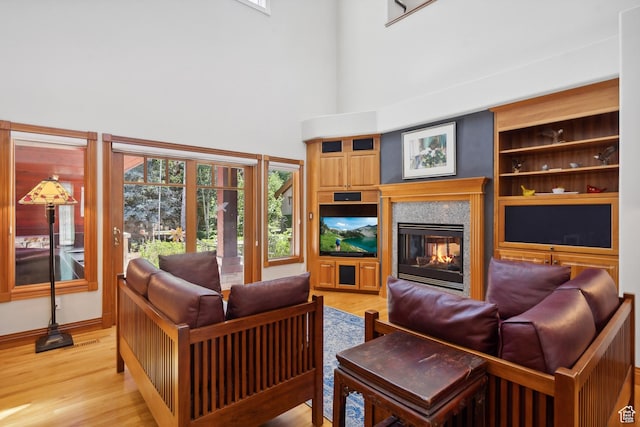 1 Spyglass Ct, Park City, UT 84060 - living room featuring built in shelves, a healthy amount of sunlight, and light hardwood / wood-style floors