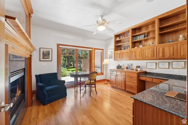 1 Spyglass Ct, Park City, UT 84060 - kitchen featuring ceiling fan, light wood-type flooring, dark stone counters, and built in desk