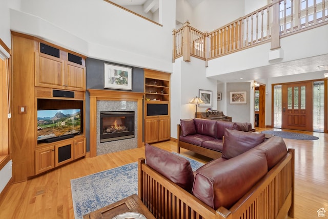 1 Spyglass Ct, Park City, UT 84060 - living room with built in features, beamed ceiling, a high ceiling, and light hardwood / wood-style floors