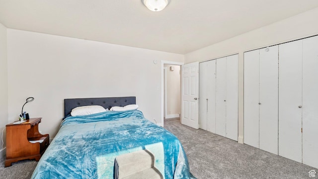 carpeted bedroom featuring two closets