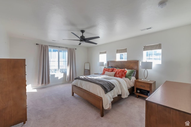 bedroom with ceiling fan and light colored carpet