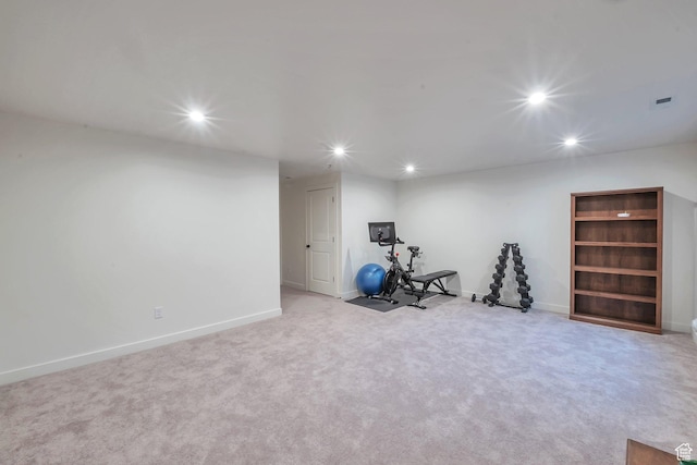 exercise room featuring light colored carpet