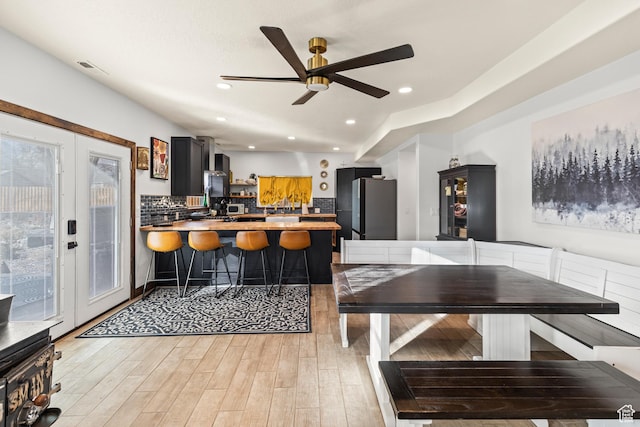 87 N 100 W, Marysvale, UT 84750 - kitchen with french doors, kitchen peninsula, stainless steel refrigerator, ceiling fan, and light hardwood / wood-style flooring