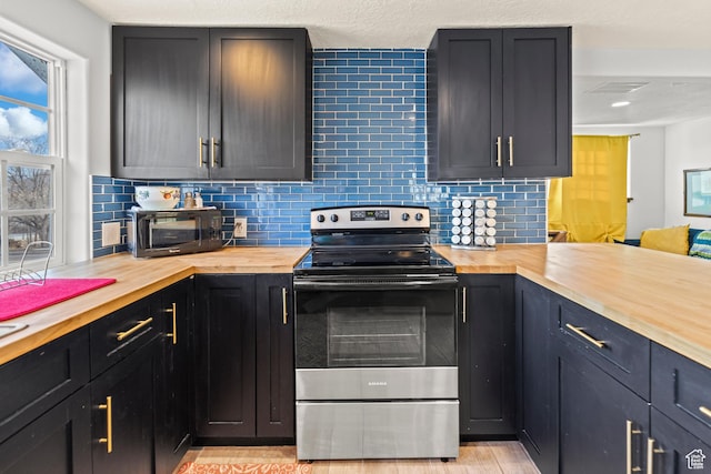 87 N 100 W, Marysvale, UT 84750 - kitchen featuring backsplash, stainless steel electric range oven, and wooden counters