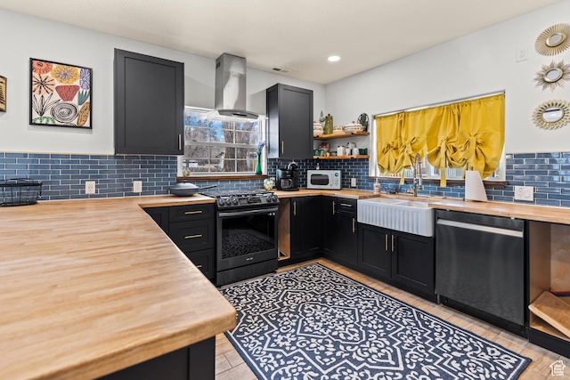 87 N 100 W, Marysvale, UT 84750 - kitchen featuring exhaust hood, sink, stainless steel range with gas stovetop, black dishwasher, and butcher block counters