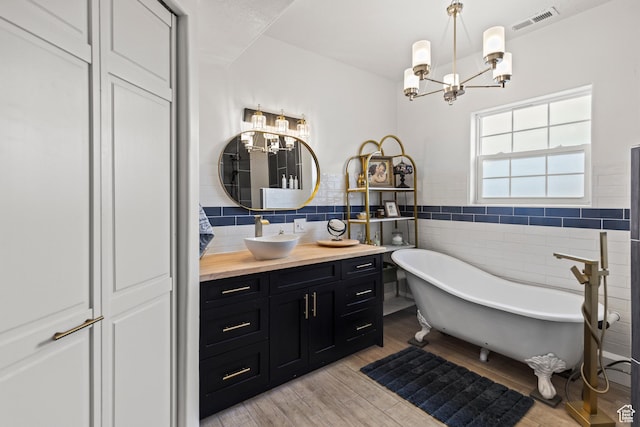 87 N 100 W, Marysvale, UT 84750 - bathroom with vanity, tile walls, a notable chandelier, and a bathing tub