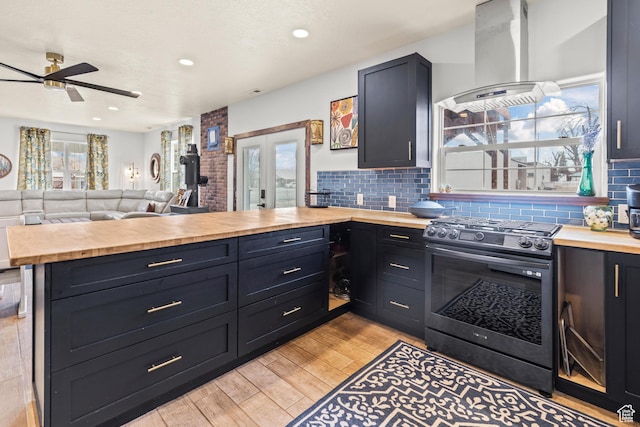 87 N 100 W, Marysvale, UT 84750 - kitchen featuring butcher block counters, island range hood, kitchen peninsula, gas stove, and french doors