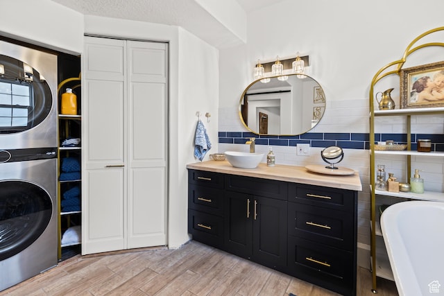 87 N 100 W, Marysvale, UT 84750 - bathroom with stacked washer / drying machine, hardwood / wood-style floors, backsplash, a bathing tub, and vanity