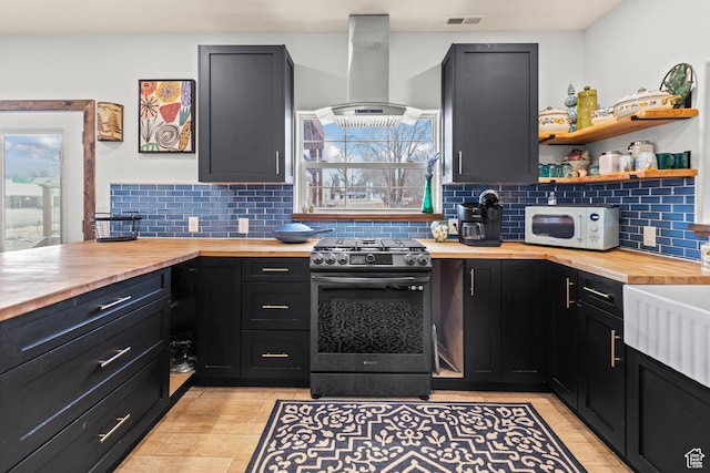 87 N 100 W, Marysvale, UT 84750 - kitchen featuring plenty of natural light, butcher block counters, island exhaust hood, and stainless steel gas range oven