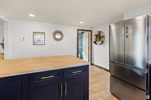 87 N 100 W, Marysvale, UT 84750 - kitchen featuring butcher block counters, blue cabinets, and stainless steel refrigerator