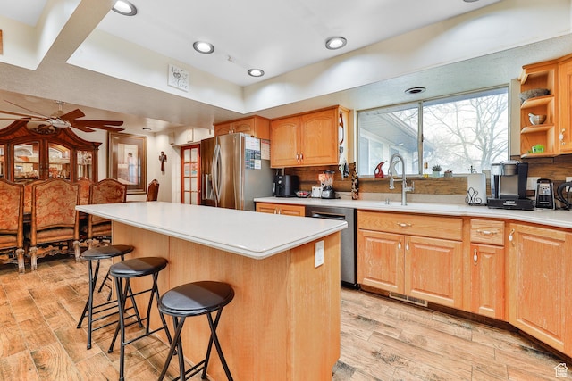 1450 E Gordon Ave N, Layton, UT 84040 - kitchen featuring ceiling fan, stainless steel appliances, a center island, a breakfast bar, and sink