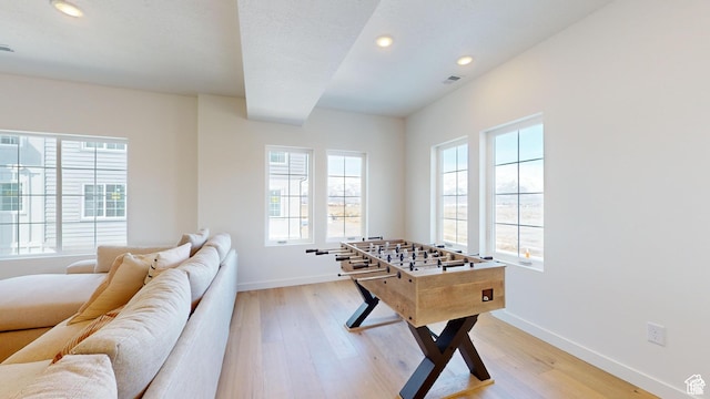 game room with light hardwood / wood-style flooring