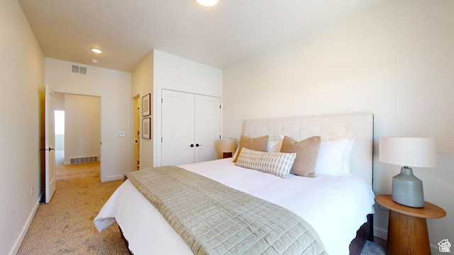 bedroom featuring a closet and light carpet