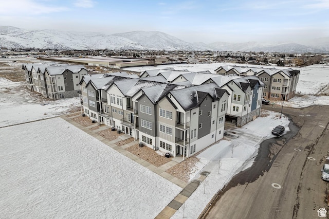 snowy aerial view featuring a mountain view