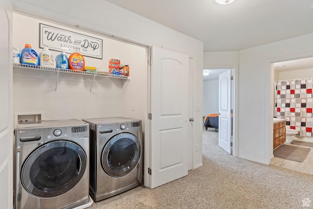 laundry room featuring baseboards, laundry area, washing machine and dryer, and light colored carpet
