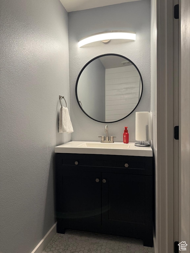 bathroom with vanity and baseboards