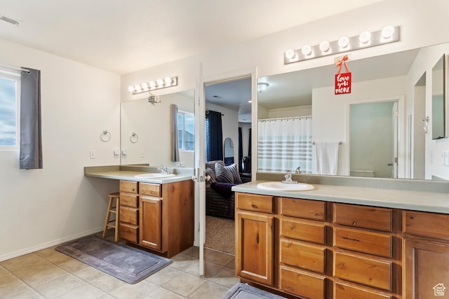 bathroom featuring tile patterned floors, vanity, and visible vents