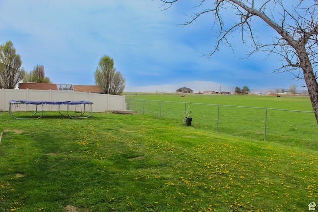 view of yard featuring a rural view and fence