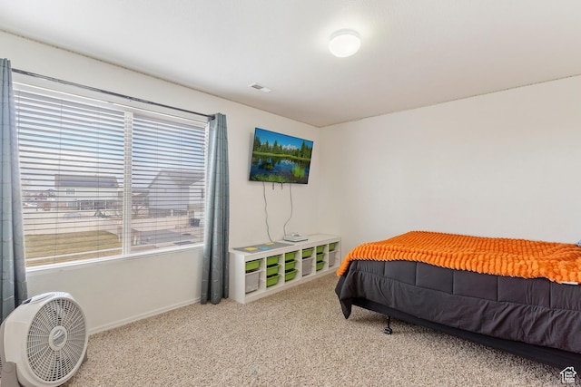 bedroom featuring baseboards and carpet flooring