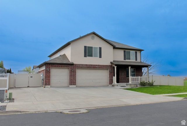 traditional home featuring covered porch, brick siding, fence, and a gate