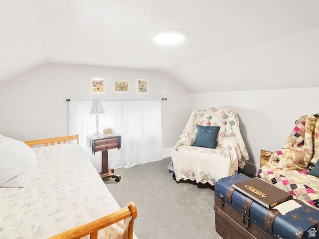 bedroom featuring vaulted ceiling and carpet floors