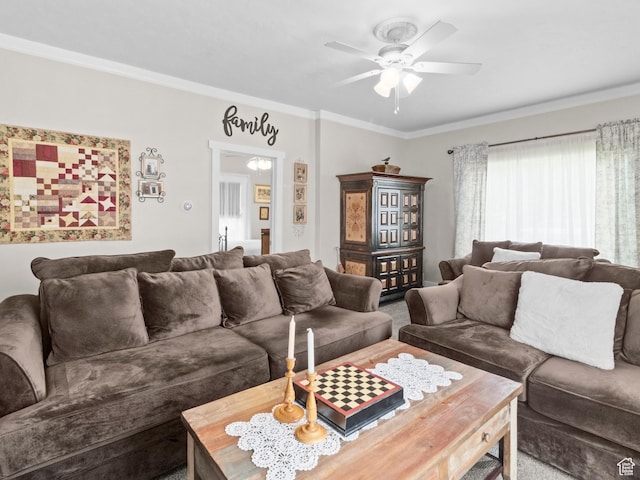 living room with carpet, ornamental molding, and ceiling fan