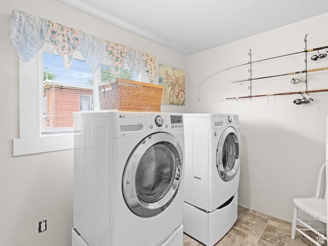clothes washing area featuring separate washer and dryer