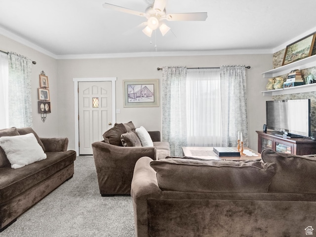 living room with carpet, crown molding, and ceiling fan