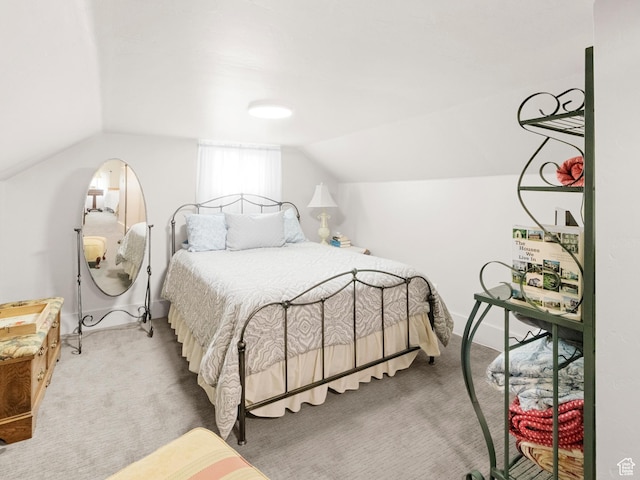 bedroom featuring vaulted ceiling and carpet floors