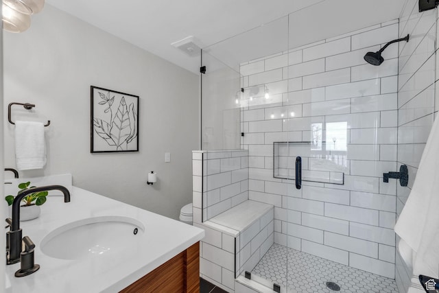 full bath featuring a sink, a shower stall, and double vanity
