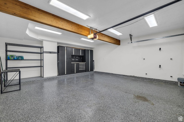 garage with a garage door opener and baseboards