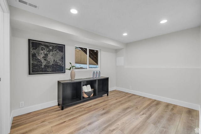 unfurnished office with wood finished floors, baseboards, visible vents, and recessed lighting