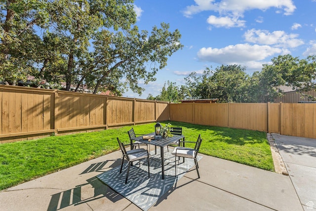 view of patio with a fenced backyard and outdoor dining space