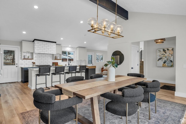 dining space featuring lofted ceiling with beams, light wood-style flooring, recessed lighting, stairs, and baseboards