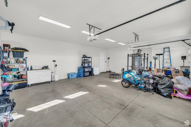garage with a workshop area and a garage door opener