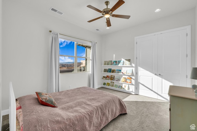 carpeted bedroom featuring ceiling fan and a closet