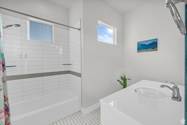 bathroom with tile patterned flooring, sink, and shower / bath combination with curtain