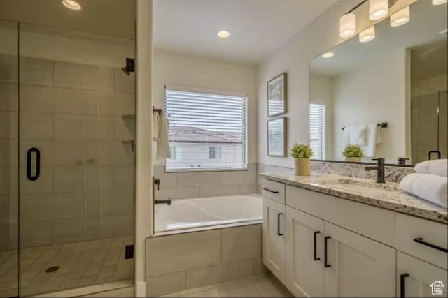 bathroom featuring tile patterned flooring, separate shower and tub, and vanity